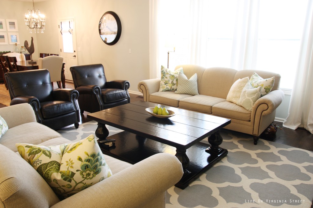 Living room with neutral furniture and blue trellis rug from the Rugs USA sale.